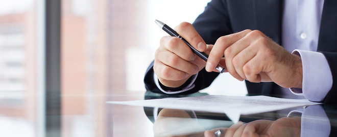 business man's hands holding a pen